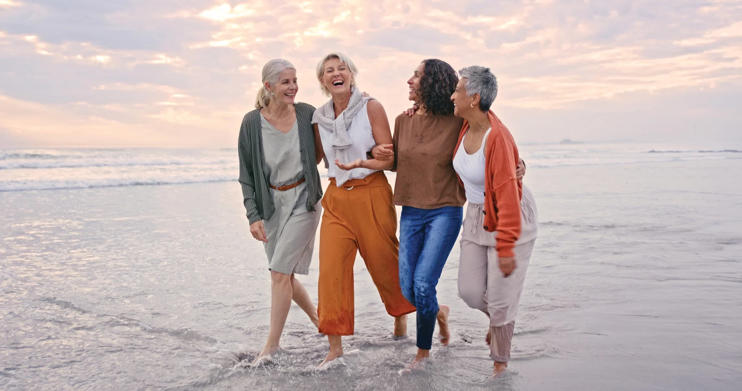 Women walking together at the water’s edge